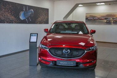 KYIV, UKRAINE - MAY 10, 2021: New red Mazda CX-5 car on display in car dealership Auto International. Crossover SUV manufactured in Japan by Mazda Motor Corporation. clipart