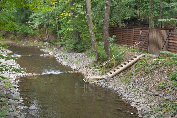 Mountain river with ladder for swimming — ストック写真