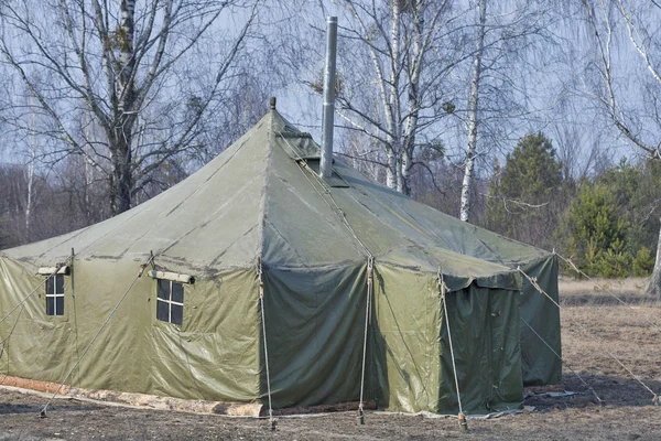 big old army expedition tent in the forest