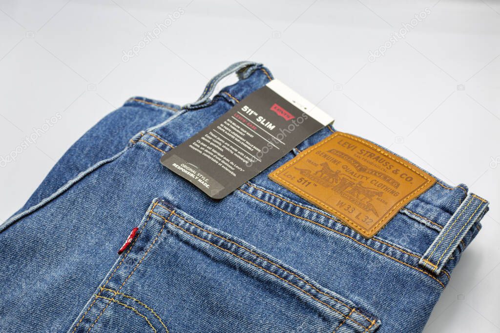 Kyiv, Ukraine - March 02, 2025: Pair of Levi's 511 jeans closeup on white. Levi Strauss and Co. is an American clothing company known worldwide for its Levi's brand of denim jeans.
