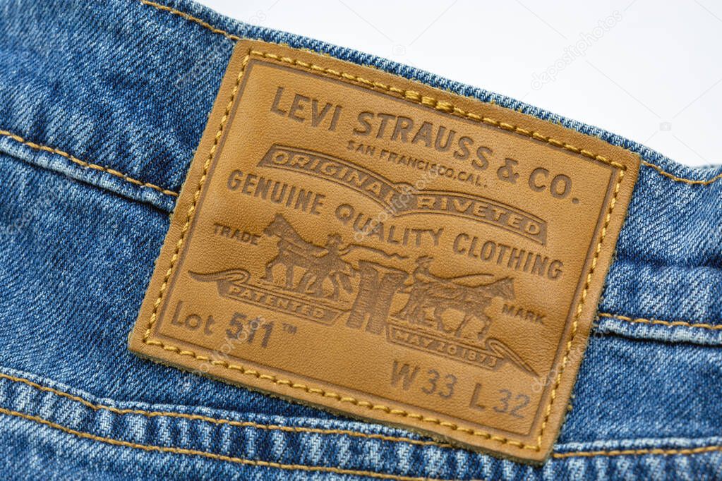 Kyiv, Ukraine - March 02, 2025: Pair of Levi's 511 jeans closeup on white. Levi Strauss and Co. is an American clothing company known worldwide for its Levi's brand of denim jeans.