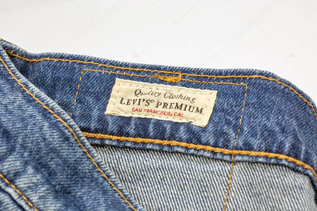 Kyiv, Ukraine - March 02, 2025: Closeup of vintage Levi's Premium quality clothing label inside blue denim jeans. Fabric tag with stitching showing San Francisco, branding and authentic craftsmanship.