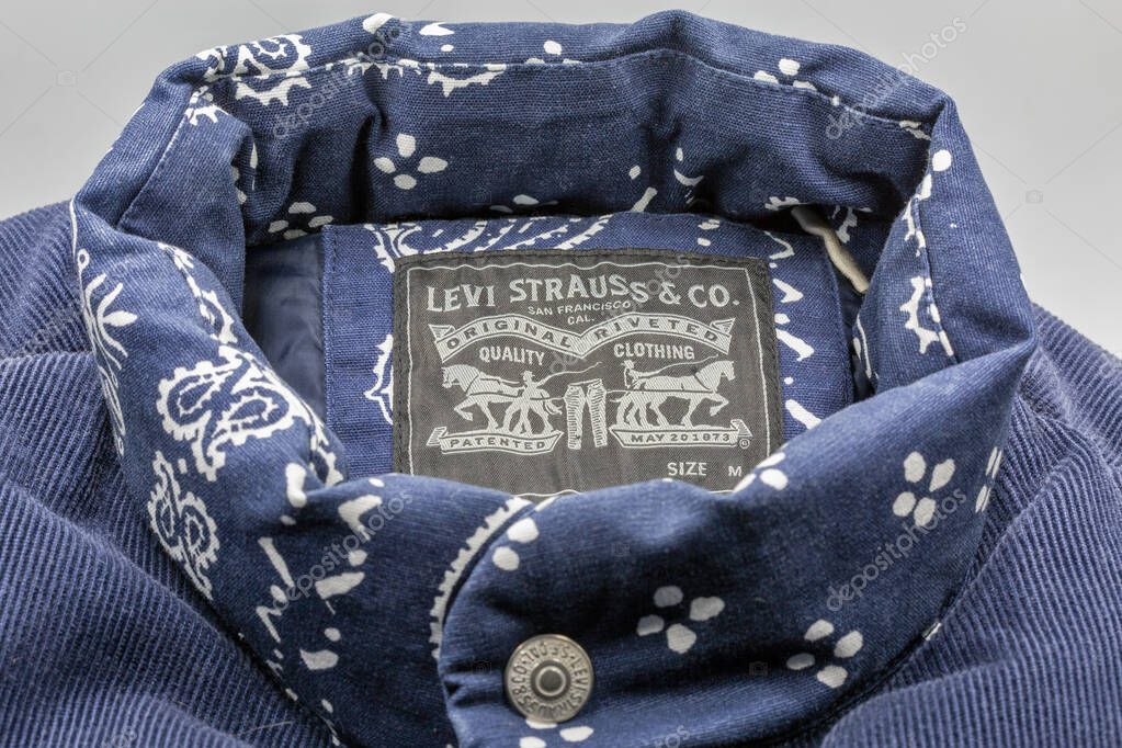Kyiv, Ukraine - October 22, 2025: Closeup of a Levi Strauss and Co. label inside a blue patterned denim jacket, showing detailed stitching and the brands classic logo tag closeup.