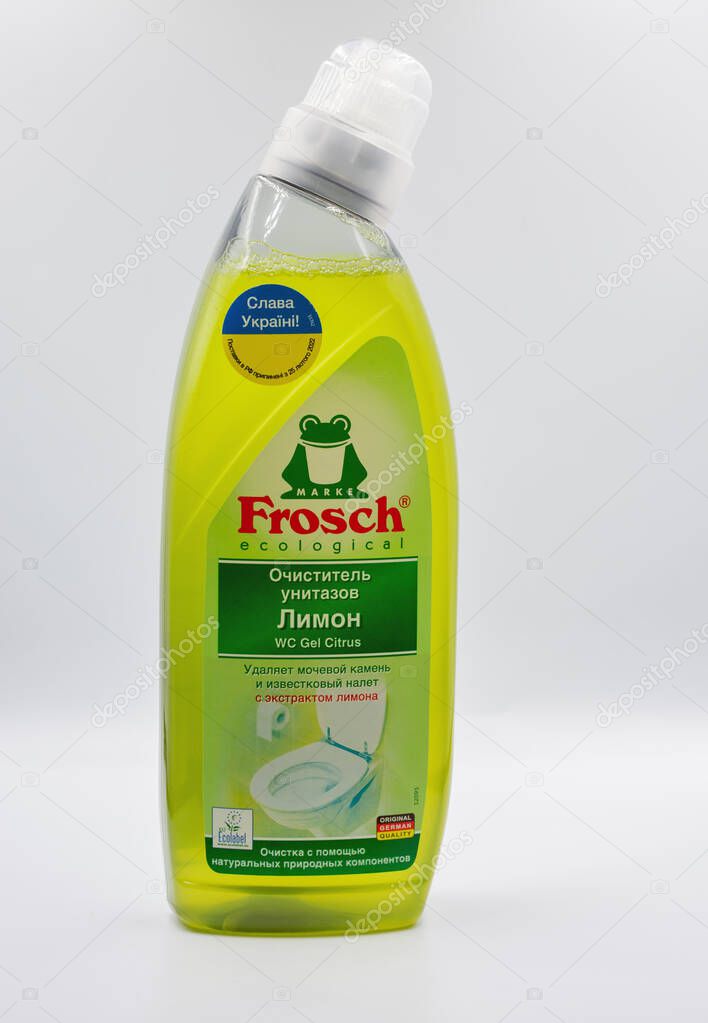 Kyiv, Ukraine - December 01, 2024: Green Frosch ecological dishwashing liquid bottle with lemon scent closeup. German brand eco-friendly dish soap in transparent plastic bottle on white surface.