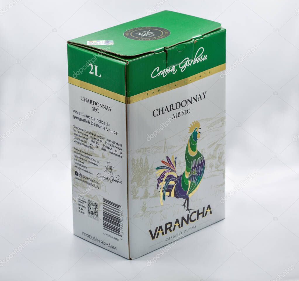 Bucharest, Romania - December 29, 2024: Crama Girboiu Varancha Chardonnay Alb Sec white wine 2L box with green top, elegant peacock illustration, Family Estate branding, Romanian wine product on white