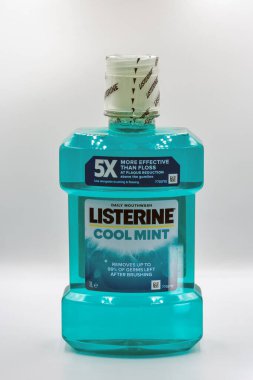 Kyiv, Ukraine - July 31, 2025: Studio shoot of Listerine Cool Mint antiseptic mouthwash bottle in turquoise blue color, 1 liter size. Product claims more effective than floss at plaque reduction.