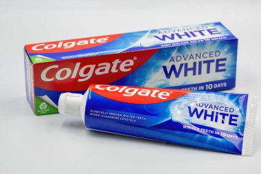 Kyiv, Ukraine - December 1, 2024: Colgate fluoride Advanced White toothpaste pack ant tube closeup on white. Colgate is a manufacturer of a wide range of toothpastes, toothbrushes, and mouthwashes.