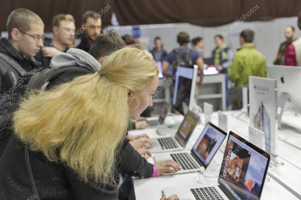 KIEV, UKRAINE - OCTOBER 11, 2015: People visit Apple, an American multinational technology company booth during CEE 2015, the largest electronics trade show of Ukraine in ExpoPlaza Exhibition Center.
