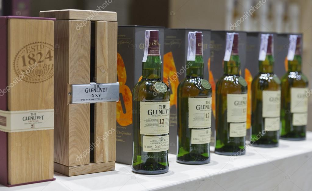 KIEV, UKRAINE - NOVEMBER 21, 2015: The Glenlivet 12 years old Single Malt Scotch Whisky bottles closeup in a row for tasting on booth at 1st Ukrainian Whisky Dram Festival in Parkovy Exhibition Center