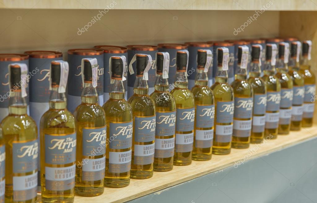 KIEV, UKRAINE - NOVEMBER 21, 2015: The Arran Lochranza Reserve Single Malt Scotch Whisky bottles closeup in a row for tasting on booth at Ukrainian Whisky Dram Festival in Parkovy Exhibition Center.