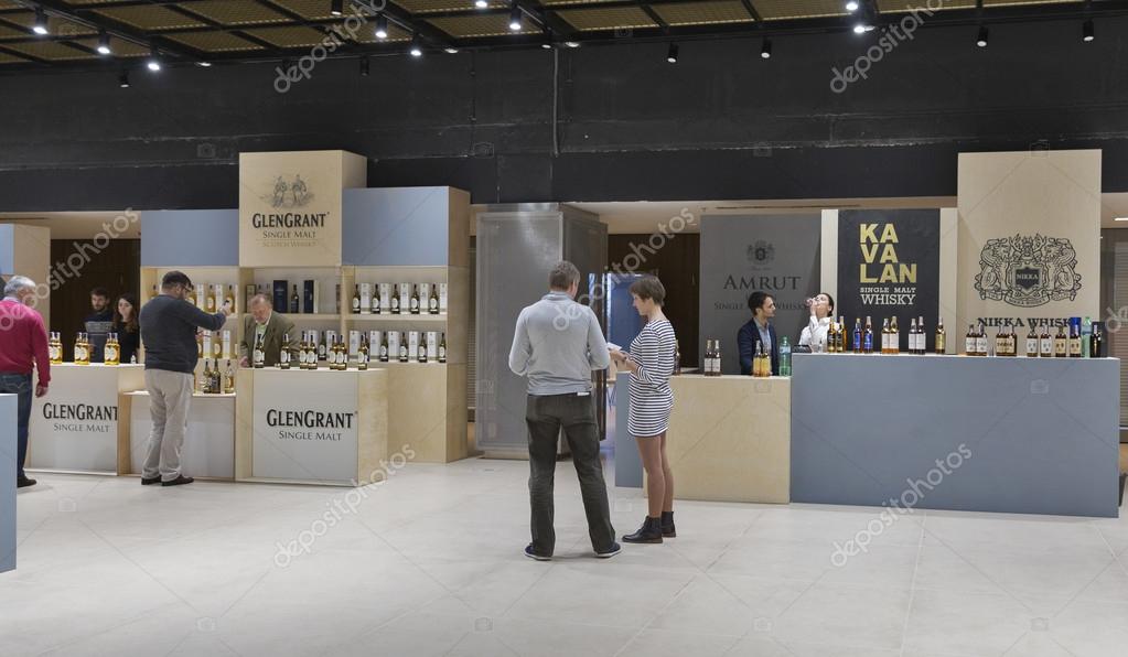 KIEV, UKRAINE - NOVEMBER 21, 2015: Unrecognized people visit Glen Grant, Amrut, Kavalan and Nikka Single Malt Scotch Whisky boothes at 1st Ukrainian Whisky Dram Festival in Parkovy Exhibition Center.