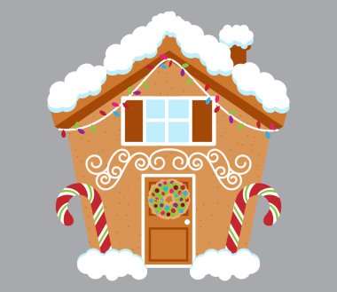 Sevimli Gingerbread House karla kaplı ve şeker ve krema ile dekore edilmiş