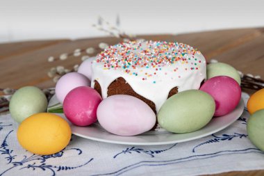 Easter cake, colorful eggs and pussy-willow on festive table