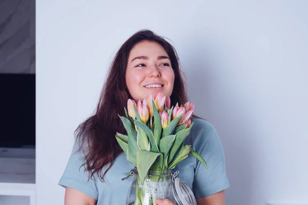 Happy Woman Pink Tulips Her Hand She Smiles Smells Flowers — Stock Photo, Image