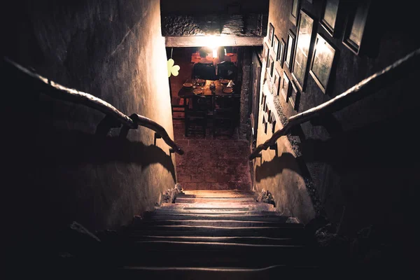 Dramatic point of view of scary stairs from upside into darkness of interior of old pub — Stock Photo, Image