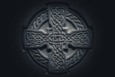 Wonderful embossed Celtic stone cross, full of details and textures in its elaborate carvings. clipart