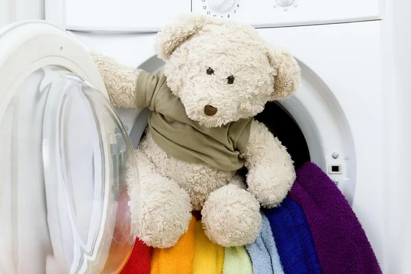 Washing machine, toy and colorful laundry to wash — Stock Photo, Image