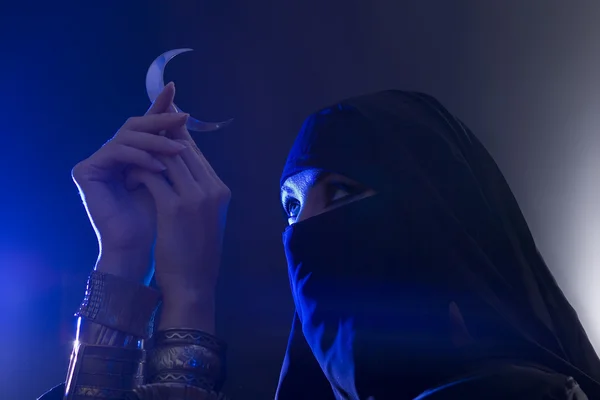 Beautiful young muslim girl holding a moon symbol, spirituality — Stock Photo, Image