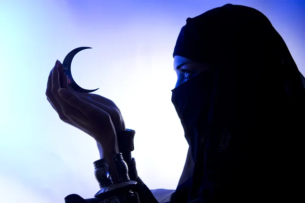 Beautiful young muslim girl holding a moon symbol, spirituality, — Stock Photo, Image