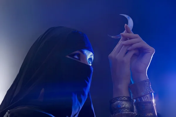 Beautiful young muslim girl holding a moon symbol, spirituality — Stock Photo, Image