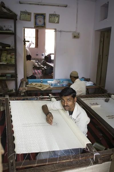 VARANASI, INDIA, DEC 9, 2013: Unidentified Indian man embroideri