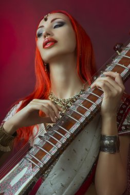 Beautiful Redhead Woman in Indian Sari with Oriental Jewelry Pla clipart