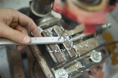 Man drilling in Steel Plate with Bench Drill. Close-up Electric
