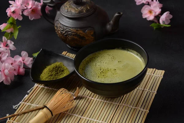 Green matcha tea drink and tea accessories on white background. Japanese tea ceremony concept. Detox tea. Antioxidant drink