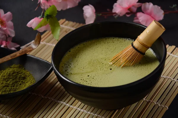 Green matcha tea drink and tea accessories on white background. Japanese tea ceremony concept. Detox tea. Antioxidant drink