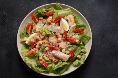Kızarmış tavuklu Sezar Salatası, salatalı Peynir ve kızarmış ekmek, tabakta. Izgara tavuk göğsü ve taze sebzeler..