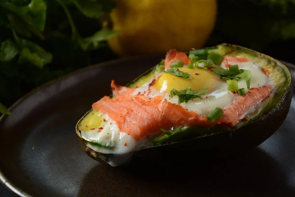 Baked smoked salmon, egg in avocado, ketogenic keto low carb diet food