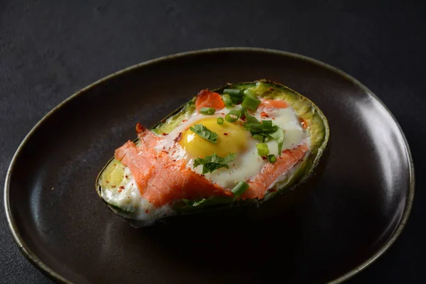 Baked smoked salmon, egg in avocado, ketogenic keto low carb diet food