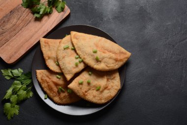 Chebureki, etli ve soğanlı kızarmış turta. Kafkas mutfağı, içi doldurulmuş kuzu eti ve baharatlı baharatla mayalanmamış hamur köftesidir..
