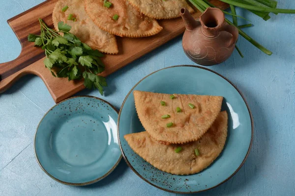 Chebureki - fried pies with meat and onions. Caucasian cuisine - is a patty made from thin unleavened dough with stuffed lamb and spicy seasonings.