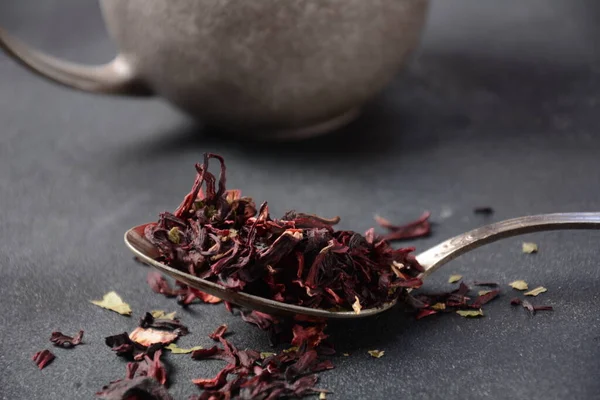 Dry Hibiscus tea in a spoon. Tea concept