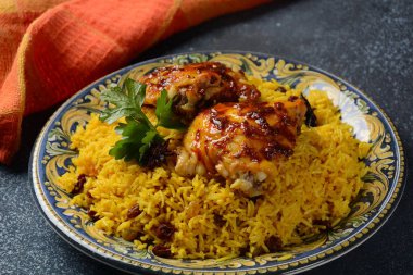 Ulusal Suudi Arabistan yemeği kızarmış tavuk kabsa ve badem, kuru üzüm, sarımsak ve biryani pilavı.