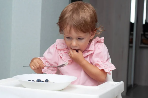 Menina Pequena Comendo Sua Aveia Mingau Manhã Com Mirtilos Ela — Fotografia de Stock