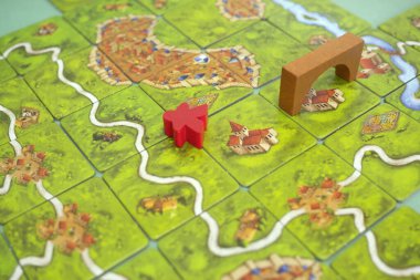 Carcassonne 'daki masa başı masa başı masa başı oyununun fayansları, fayansları, kaleleri ve nehri var. Popüler aile hobisi masa oyunu. Minsk, Belarus - 10 Temmuz 2021.