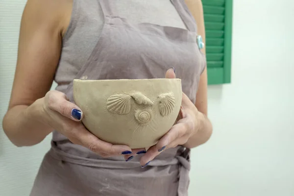 Femme potier main tenant produit d'argile fini dans un atelier de poterie studio. Art et artisanat artisanal concept de passe-temps — Photo