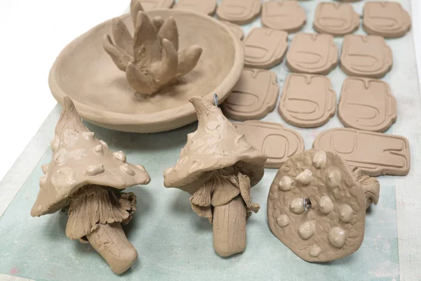 stock image Creative handmade clay products on a shelf in a pottery workshop. Product without glazing and before firing in the oven