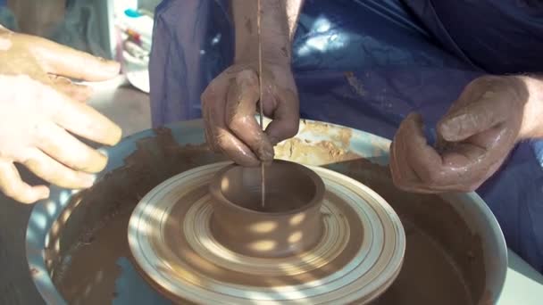 Guru pemahat roda tembikar wanita menjelaskan bagaimana bekerja dan mengajar untuk bekerja dengan tanah liat dan membuat cangkir dan kendi. Master kelas dan kursus tembikar — Stok Video