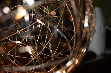 Bakır kablolar, kablolar ve evin karanlık gecesinde romantik ışıklar eşliğinde Noel tatillerinin soyut sanatsal kompozisyonu.