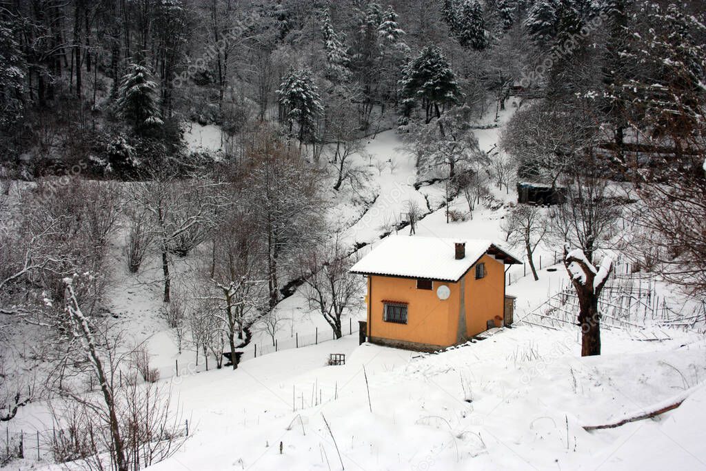 lonely modern cabin in the mountain peak among the white winter snow in tuscany