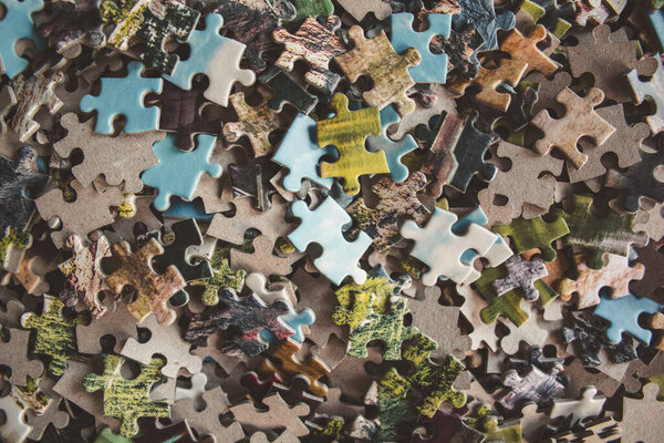 Jigsaw puzzle. Pile of jigsaw puzzle peices. Conceptual photo with focus on undone puzzle