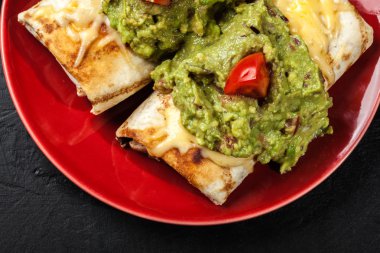 Mexican chimichanga with guacamole dip clipart