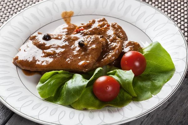 Pork chop with sauce and vegetables — Stock Photo, Image