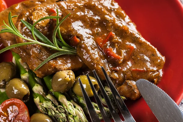 Pork chop with sauce and asparagus — Stock Photo, Image