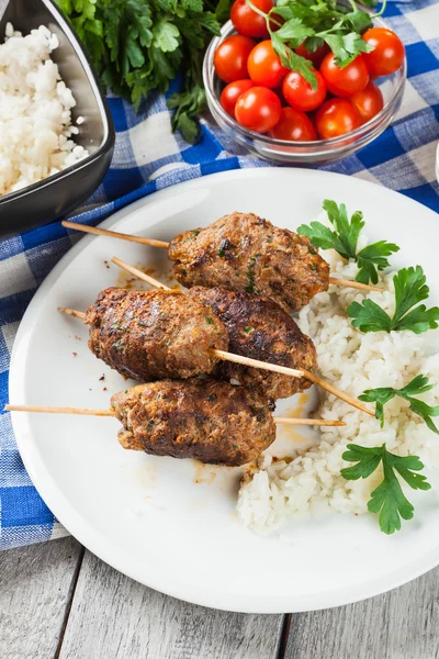 Barbecued kofta with rice on a plate — Stock Photo, Image