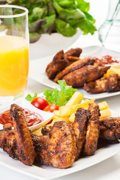 Chicken wings with fries french and spicy sauce — Stock Photo, Image