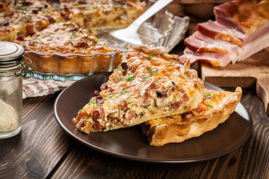 Pieces of quiche lorraine with bacon and cheese. French cuisine clipart